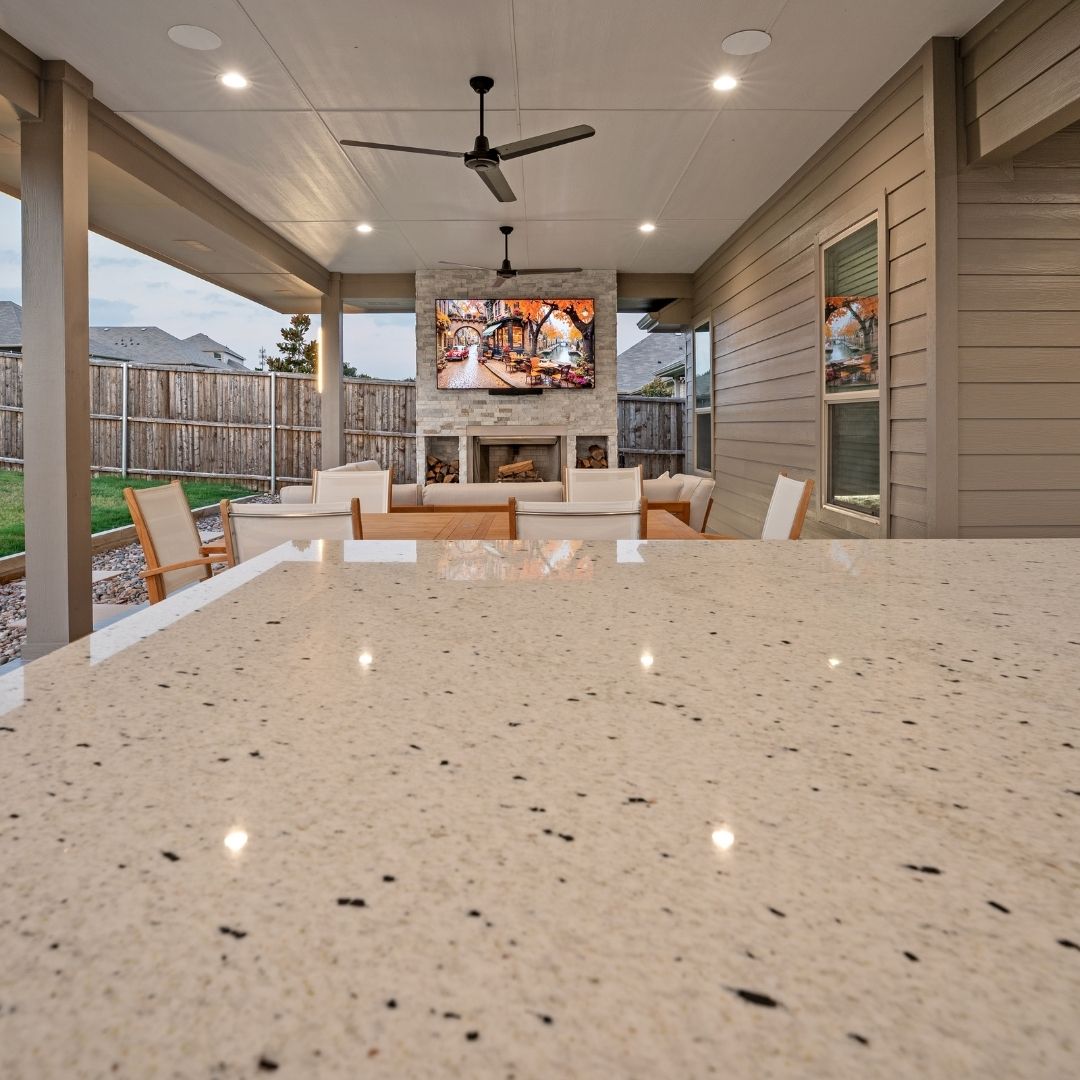 The view from an outdoor kitchen to the rest of the patio.