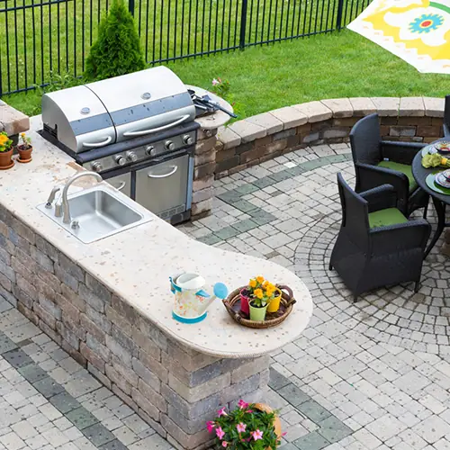 Covered outdoor kitchen with stone counters