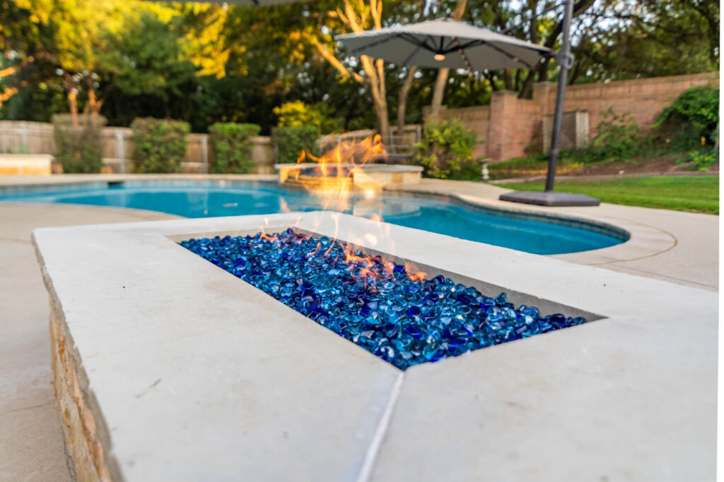 outdoor fireplace and pool
