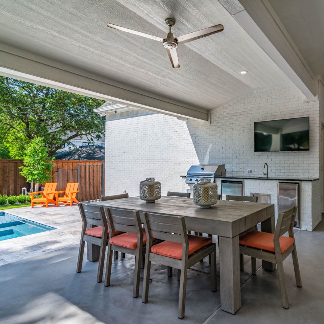 pool house with both a seating area and kitchen area