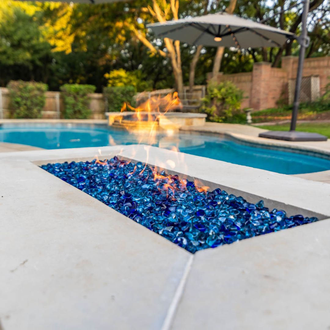 Close-up of a sleek, modern outdoor fire pit emitting flames