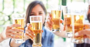 group of friends making a toast with beer