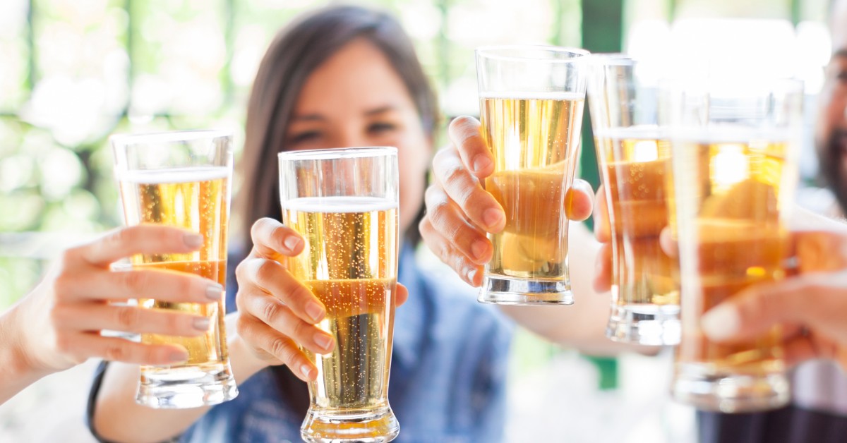 group of friends making a toast with beer