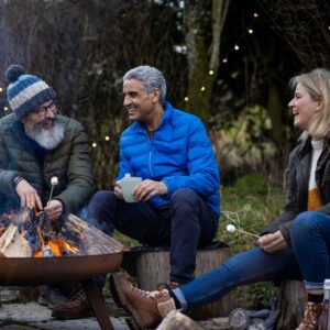 friends gathered around an outdoor fireplace