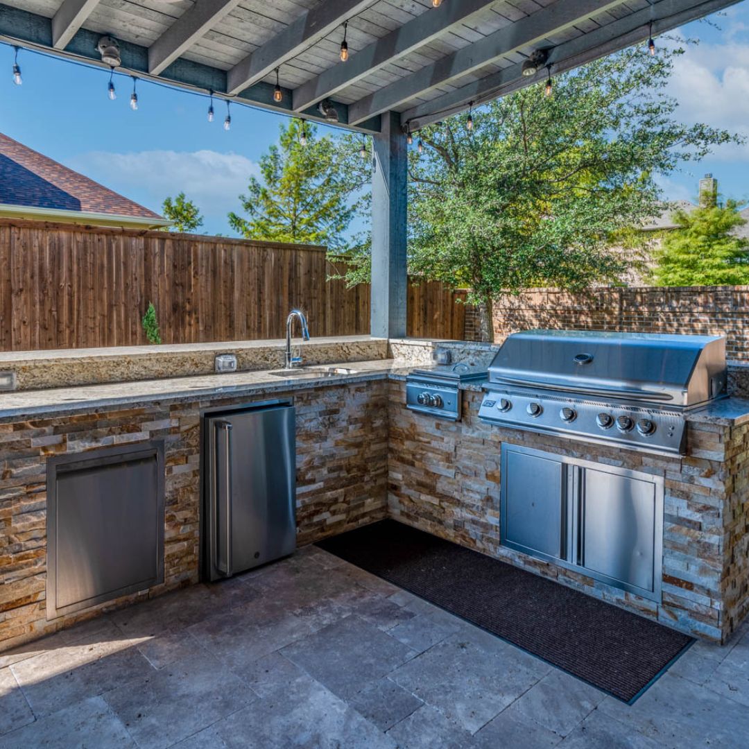 an outdoor kitchen with built in appliances