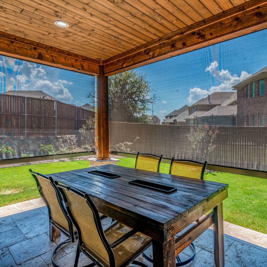 an outdoor table looking out to a backyard