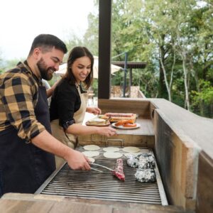 A couple grilling at their outdoor kitchen in DFW area. 