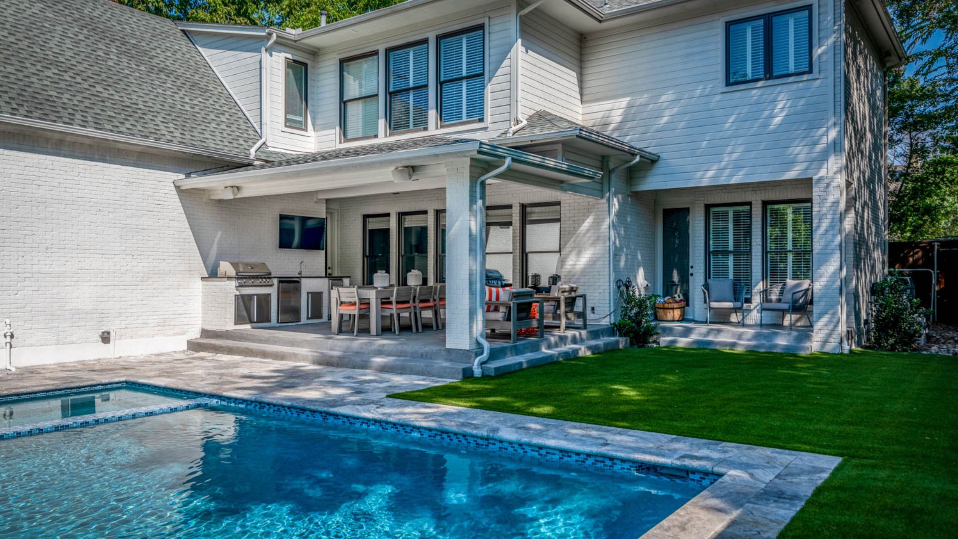 outdoor living space with an outdoor kitchen and pool