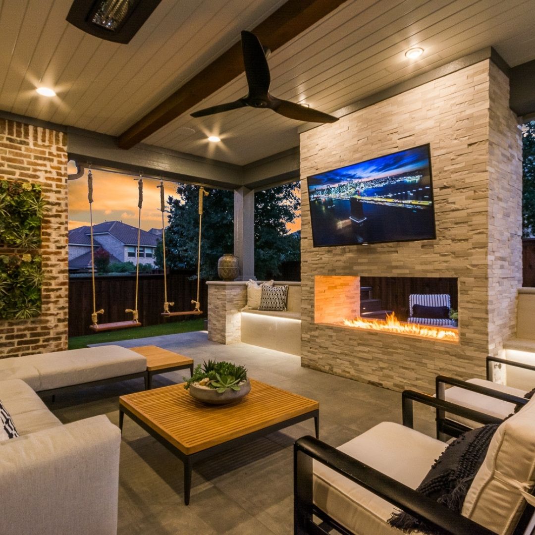 backyard patio designed with a seating area and fireplace