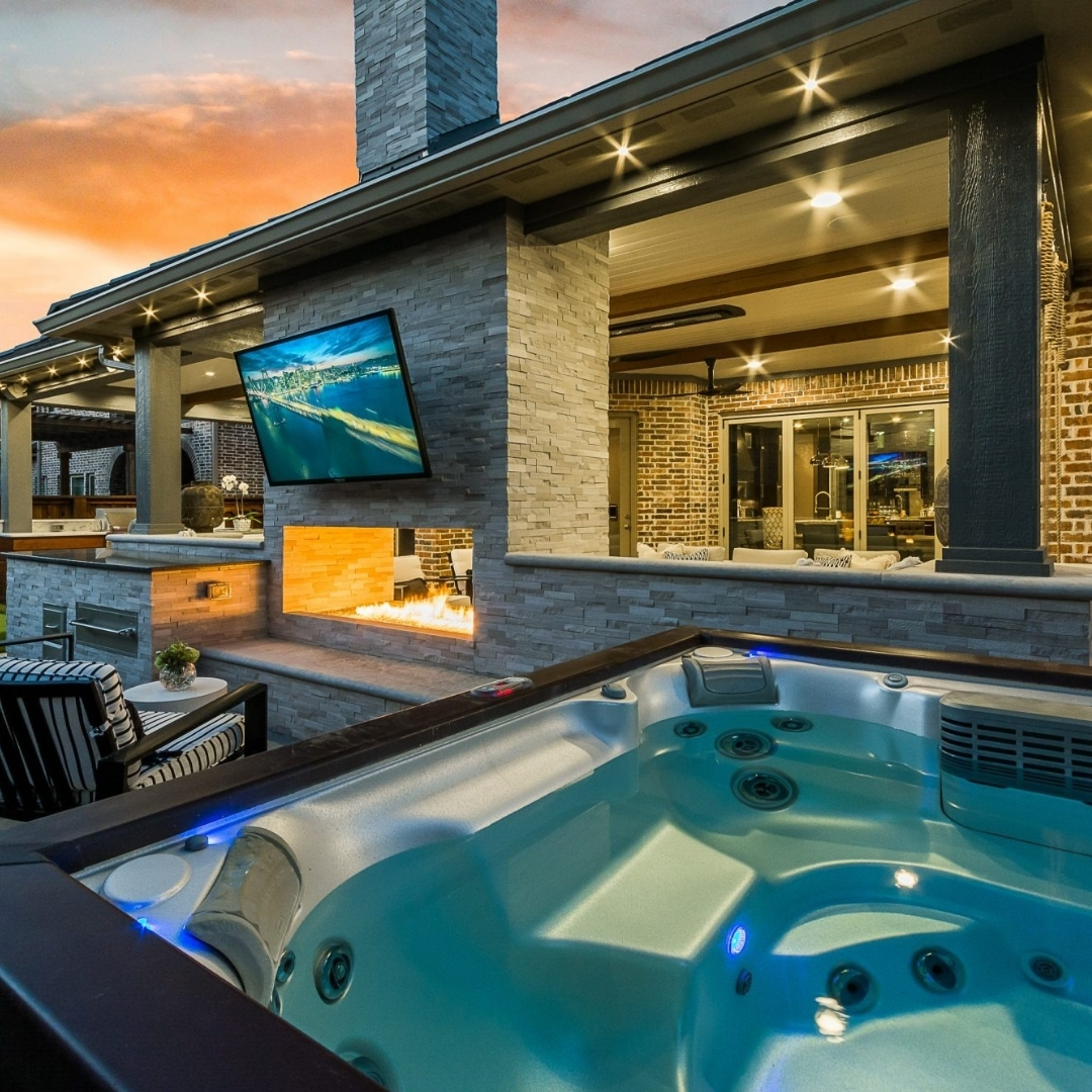 Hot tub facing a TV mounted for an outdoor space