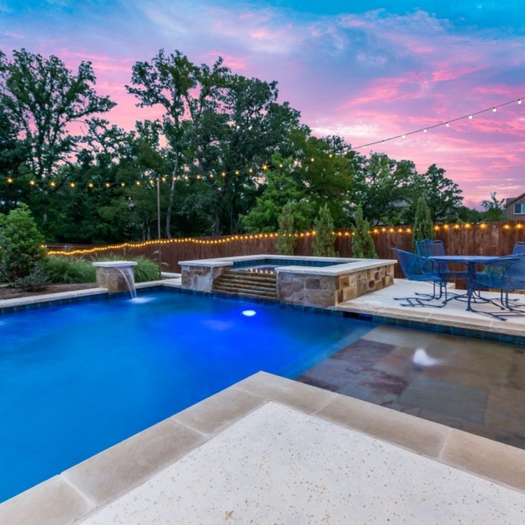 Blue residential pool at sunset